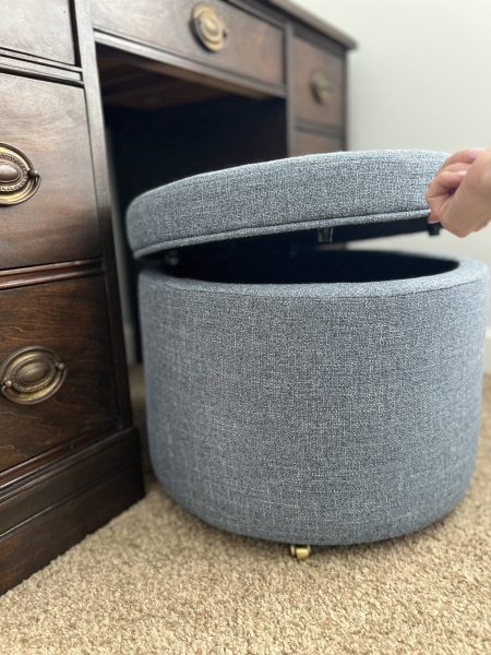A rolling storage ottoman that doubles as a kids desk chair