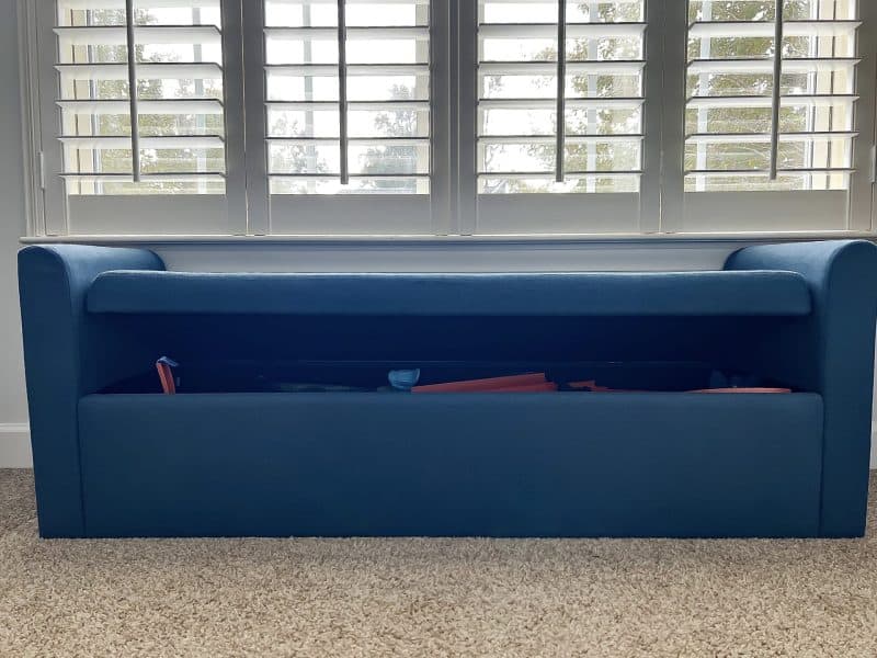 A Window Seat that has storage for  Hot Wheels Tracks and Accessories 