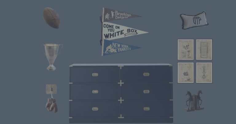 A navy blue dresser adorned with sports memorabilia, including pennants for the Brooklyn Dodgers and Chicago White Sox, a trophy, a football, and vintage illustrations hanging on the wall.