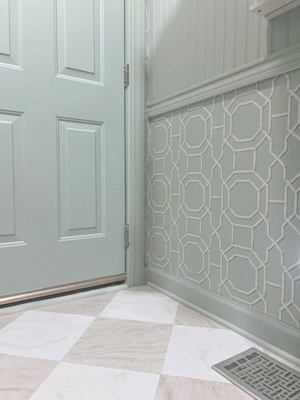 light green laundry room with coastal Schumacher inspired wallpaper and checkerboard tile