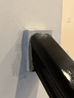 Before image of the staircase showing the outdated and damaged railing rosette prior to the DIY upgrade. Learn how to upgrade a staircase with simple steps.