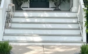 Freshly painted exterior stairs with smooth wood and crisp white and gray finish after wood stair repair