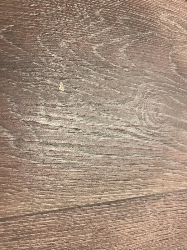 Close-up of a wooden surface with a textured grain pattern in shades of brown.