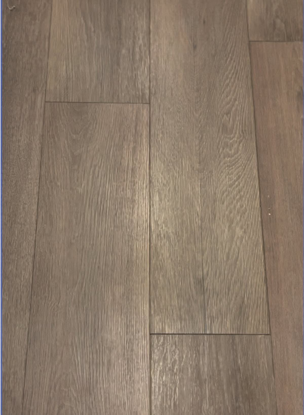 Close-up view of a wooden floor with a textured, light brown finish.