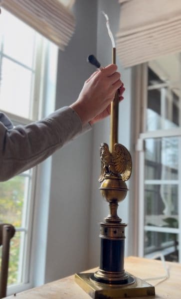 an image of measuring threaded pipe to replace lamp wire