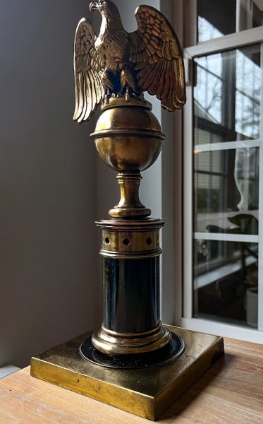 an image of a vintage lamp with a brass eagle and black and brass accents