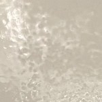 Spray-painted surface with a bumpy, dimpled texture resembling an orange peel, caused by spraying from too far away or applying thick coats.