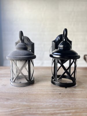 Side-by-side images of an outdoor wall sconce before and after being spray-painted black, showing a refreshed and modernized look.