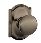 Antique bronze round door knob with decorative plate for interior use.