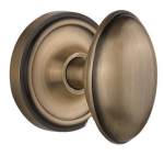 Close-up of a vintage-style brass knob with a round plate, showcasing its elegant design and finish.