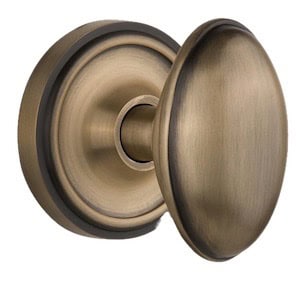 Close-up of a vintage-style brass door knob with a round plate, showcasing its elegant design and finish.