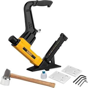 A Dewalt flooring nailer kit featuring a yellow and black nail gun, a wood mallet, a bottle, two white spacers, and several Allen wrenches.