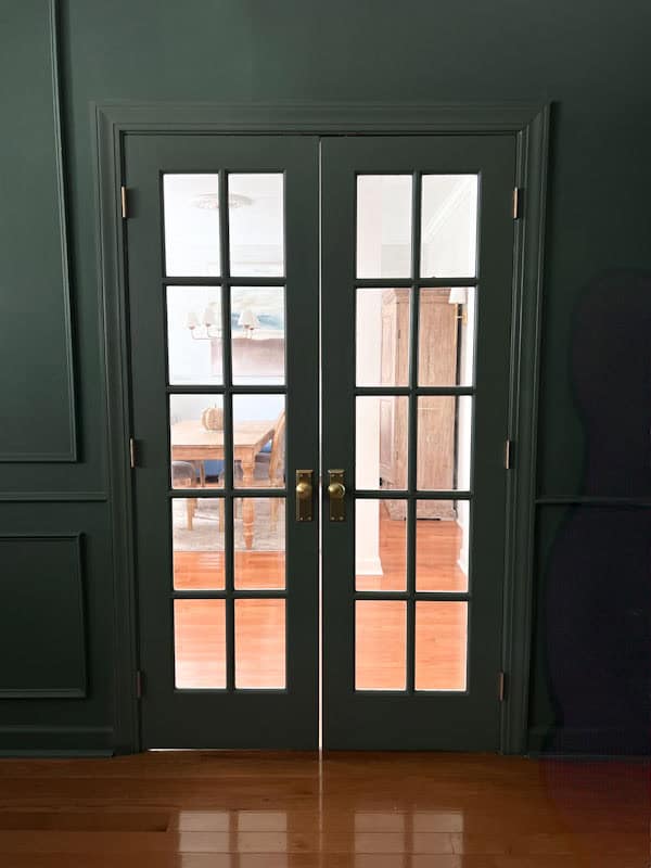 French doors painted in a dark green after color drenching a home office