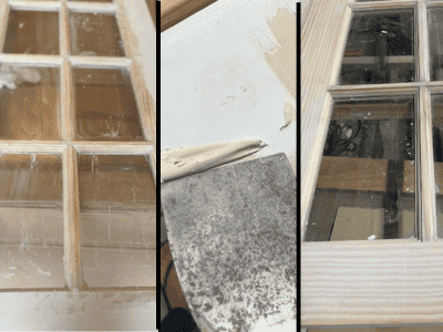 A wooden door with six-pane glass sections, showing unfinished wood and a partially scraped surface.