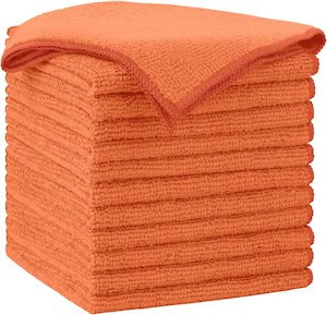a stack of orange microfiber cleaning cloths
