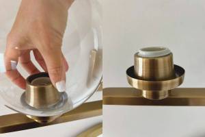 Removing glass shades and installing linen clip-on chandelier shades on bathroom vanity lights.