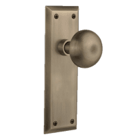 Vintage-style Nostalgic Warehouse interior door knob on a decorative plate.