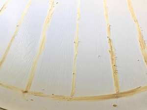 Close up of Filling grooves in dining table using epoxy wood filler