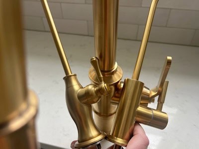 Close-up of various brass faucet finishes showing different textures and colors.