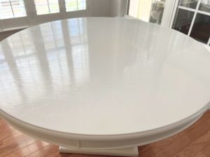 Smooth white dining table after filling grooves between boards