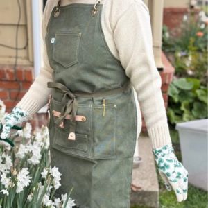waxed canvas gardening apron with pockets for tools while working in a home garden