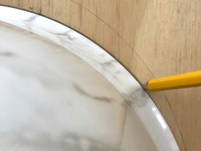 Tracing curved decorative bracket shape onto wood for DIY shelf support