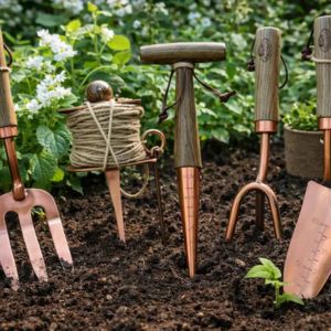 pretty copper gardening tools set with hand tools in soil for home garden use
