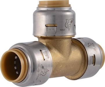 Brass T-shaped plumbing fitting with metal and plastic components for outdoor shower setup.