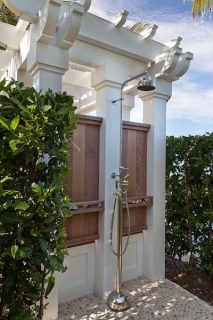 shower fixture is mounted directly to the exterior pillar and surrounded by wood framing