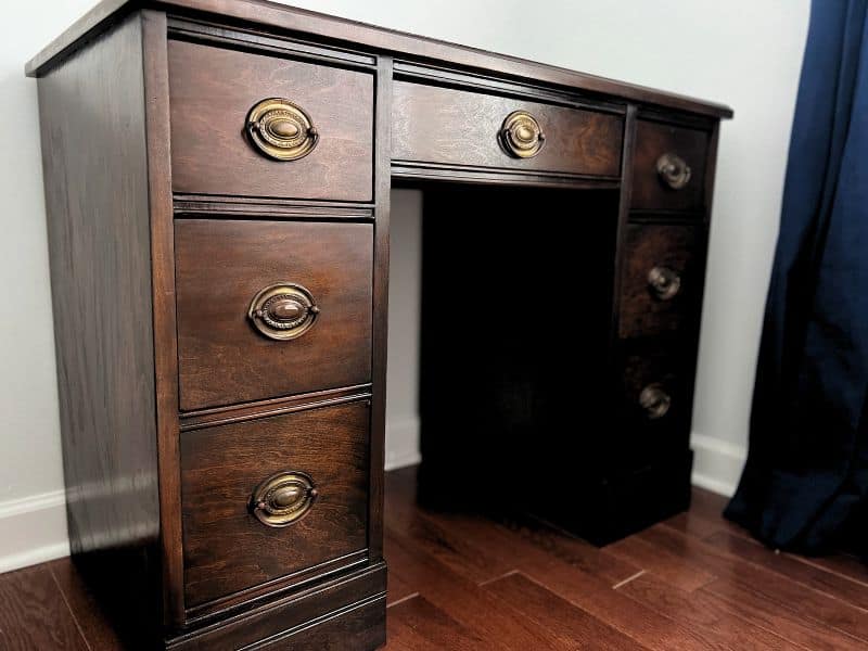 Side view of a refinished wood desk with gel stain